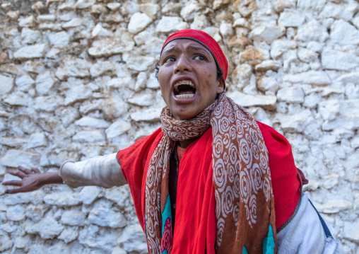 Sufi woman with a red veil into trance during a muslim ceremony, Harari Region, Harar, Ethiopia