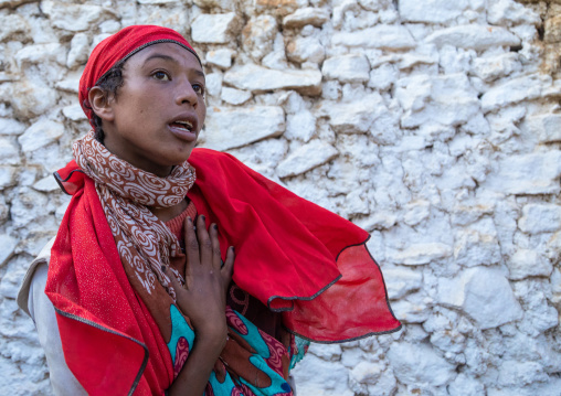 Sufi woman with a red veil into trance during a muslim ceremony, Harari Region, Harar, Ethiopia