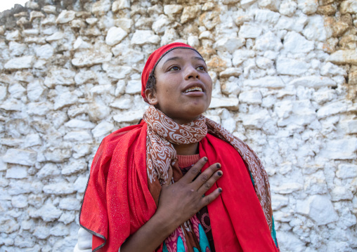 Sufi woman with a red veil into trance during a muslim ceremony, Harari Region, Harar, Ethiopia