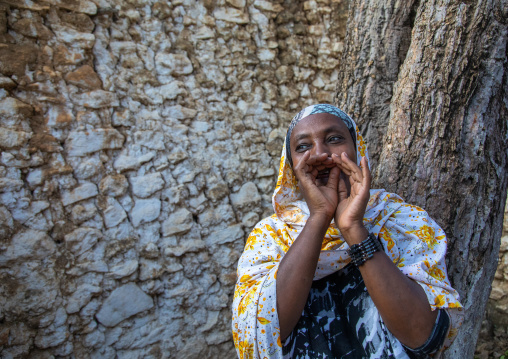 Veiled harari woman making ululation during a muslim ceremony, Harari Region, Harar, Ethiopia