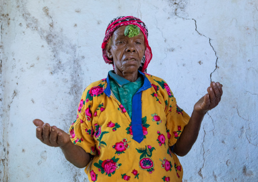 Ethiopian muslim woman praying with basil on her head, Harari Region, Harar, Ethiopia