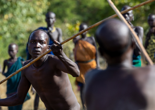 Suri tribe warriors fighting during a donga stick ritual, Omo valley, Kibish, Ethiopia