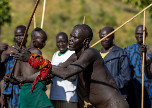 Suri tribe warriors fighting during a donga stick ritual, Omo valley, Kibish, Ethiopia