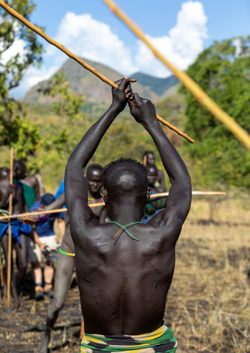 Suri tribe warriors fighting during a donga stick ritual, Omo valley, Kibish, Ethiopia