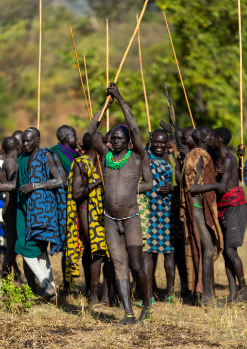 Suri tribe warriors parading before a donga stick fighting ritual, Omo valley, Kibish, Ethiopia