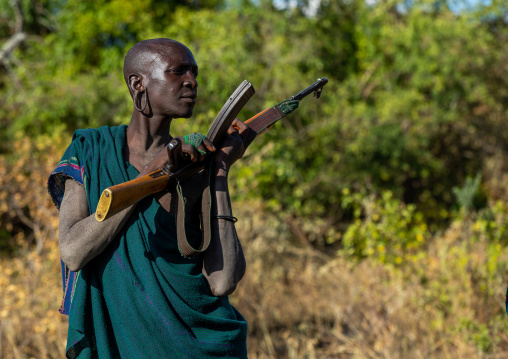 Suri tribe warrior with a kalashnikov, Omo valley, Kibish, Ethiopia