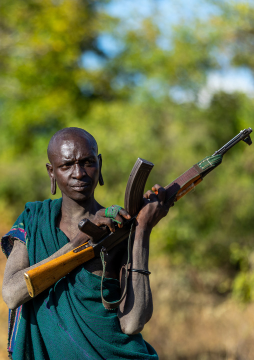 Suri tribe warrior with a kalashnikov, Omo valley, Kibish, Ethiopia