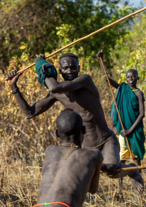 Suri tribe warriors fighting during a donga stick ritual, Omo valley, Kibish, Ethiopia