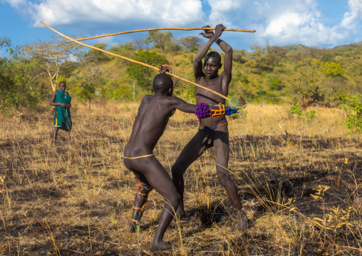 Suri tribe warriors fighting during a donga stick ritual, Omo valley, Kibish, Ethiopia