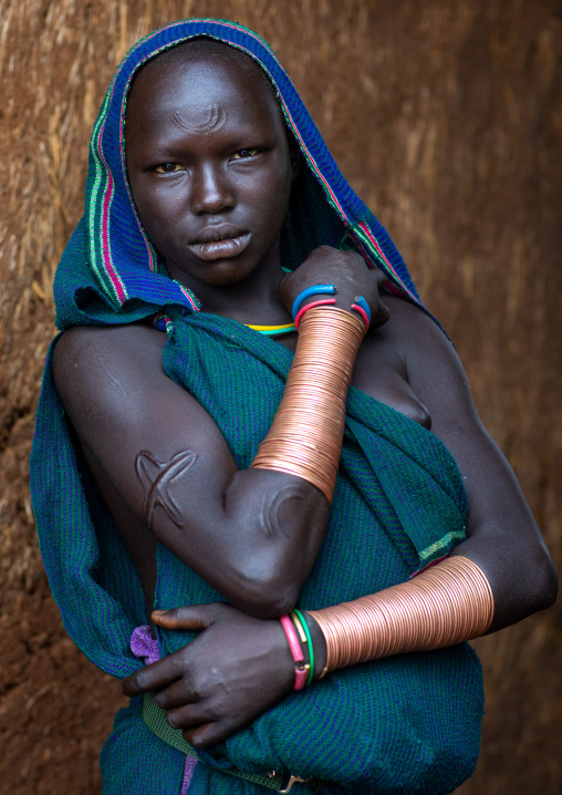 Portrait of a suri tribe woman with impressive bracelets, Omo valley, Kibish, Ethiopia