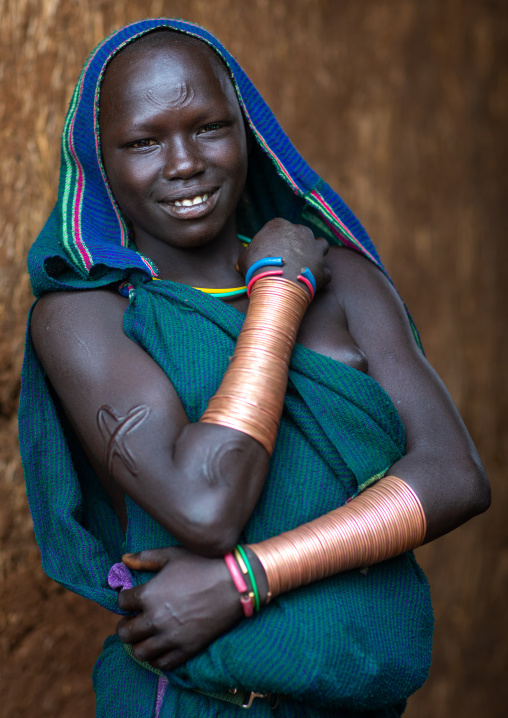 Portrait of a suri tribe woman with impressive bracelets, Omo valley, Kibish, Ethiopia