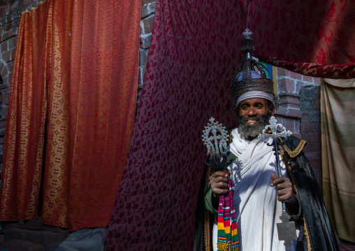 Ethiopian orthodox priest in nakuto lab rock church holding a cross, Amhara Region, Lalibela, Ethiopia