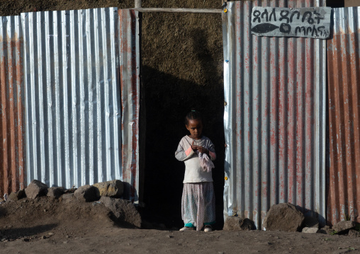 Ethiopian girls at the entrance of her house, Amhara Region, Lalibela, Ethiopia