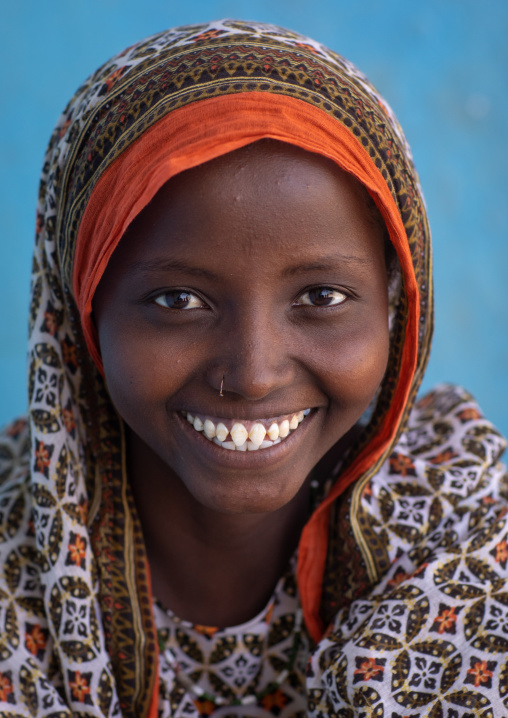 Portrait of a veiled smiling afar tribe girl with sharpened teeth, Afar Region, Afambo, Ethiopia