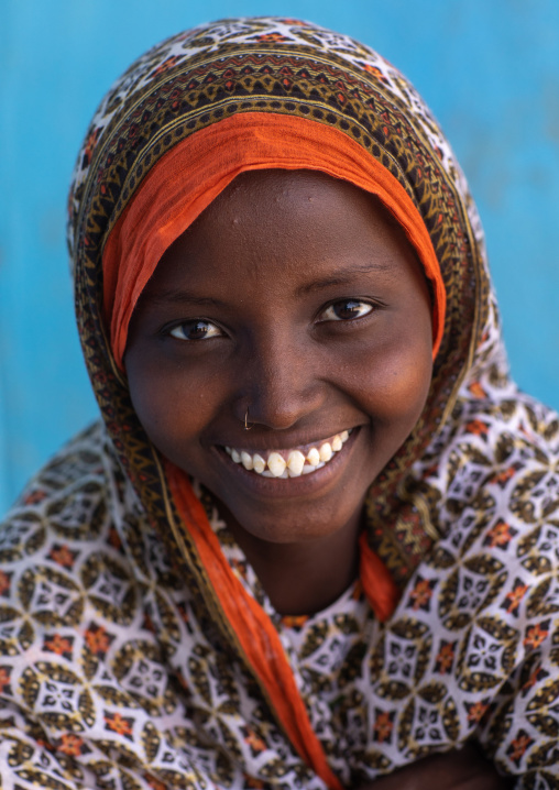 Portrait of a veiled smiling afar tribe girl with sharpened teeth, Afar Region, Afambo, Ethiopia