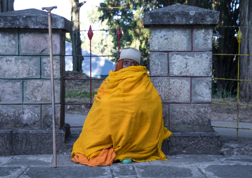 Priest covered in an yellow shawl in Entoto orthodox Maryam Church, Addis Ababa Region, Addis Ababa, Ethiopia