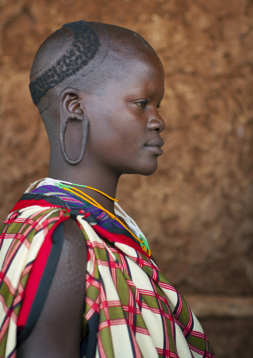 Suri tribe girl with enlarged earlobe, Kibish, Omo valley, Ethiopia