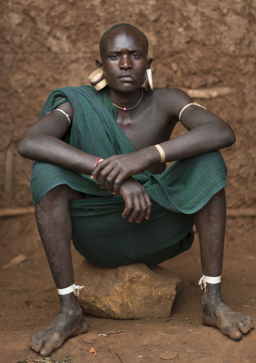 Suri tribe man with enlarged earlobes, Kibish, Omo valley, Ethiopia