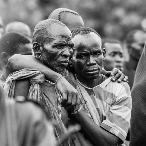 Suri Tribe Men Holding Eachother At A Ceremony Organized By The Government, Kibish, Omo Valley, Ethiopia