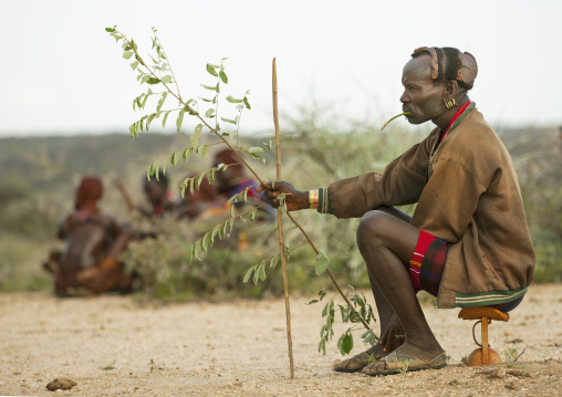 Hamar Tribe Man Sitting On A Headrest At Bull Jumping Ceremony, Turmi, Omo Valley, Ethiopia