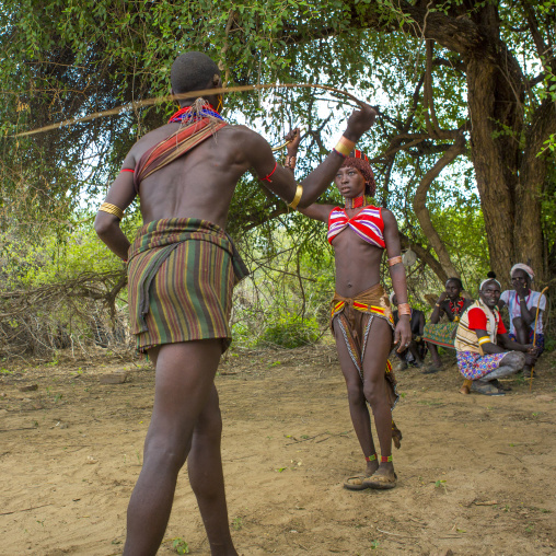 Whipping During Bull Jumping Ceremony In Hamar Tribe, Turmi, Omo Valley, Ethiopia