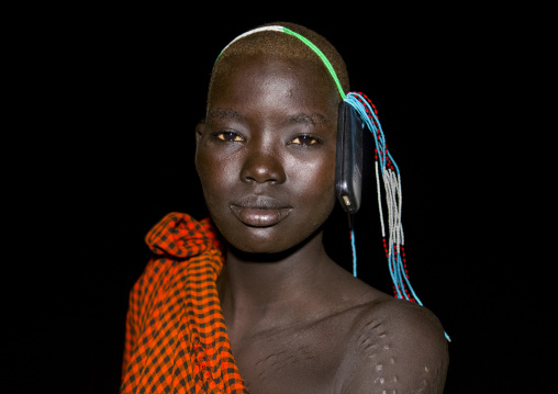 Bodi Tribe Young Woman With Her Mobile Phone On Her Head, Hana Mursi, Omo Valley, Ethiopia