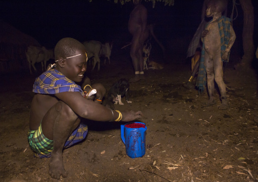 Bodi Tribe Woman Preparing Blood Drink For The Fat Men, Hana Mursi, Omo Valley, Ethiopia