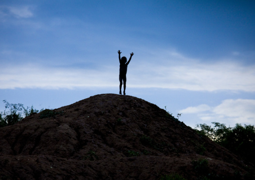 Banna Tribe Kid Jumping On A Hill, Omo Valley, Ethiopia