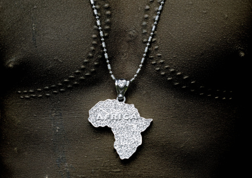 Close Up On The Chest Of A Mursi Man With Silver Africa-shaped Necklace And Scarifications, Omo Valley, Ethiopia