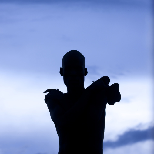 Nyangatom Tribe Man Silhouette On A Blue Sky Background, Omo Valley, Ethiopia