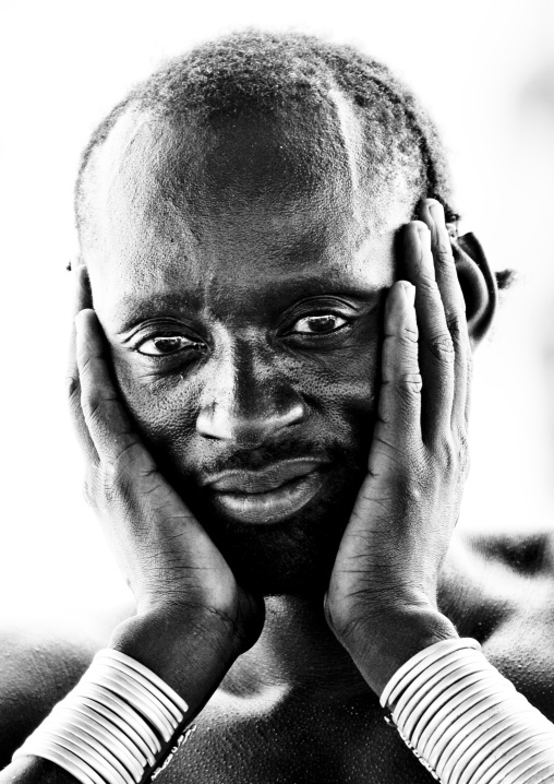 Black And White Portrait Of A Karo Tribe Man Holding His Head, Korcho Village, Ethiopia