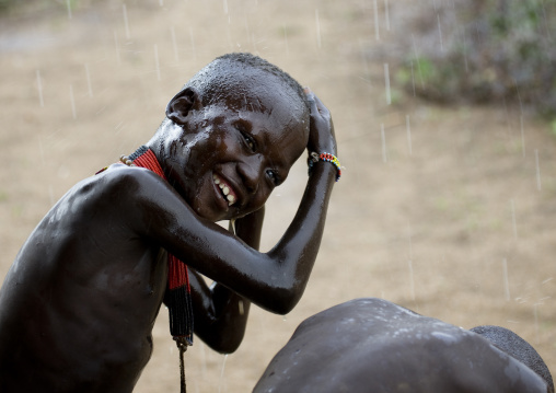 Kids From Karo Tribe Having A Shower Under The Rain, Korcho Village, Omo Valley, Ethiopia