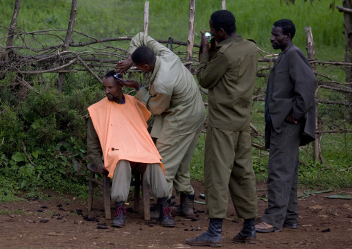 Man receiving a haircut in the street, Addis ababa, Ethiopia