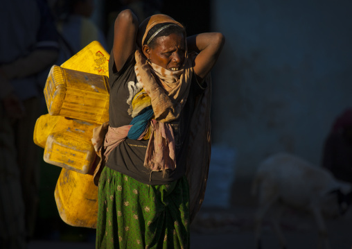 Ethiopian Woman With Cans, Harar, Ethiopia