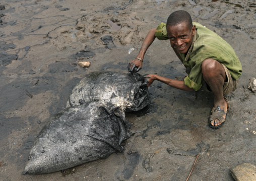 Borana Tribe Man Preparing A Bag Of Salt In El Sod Volcano, Ethiopia