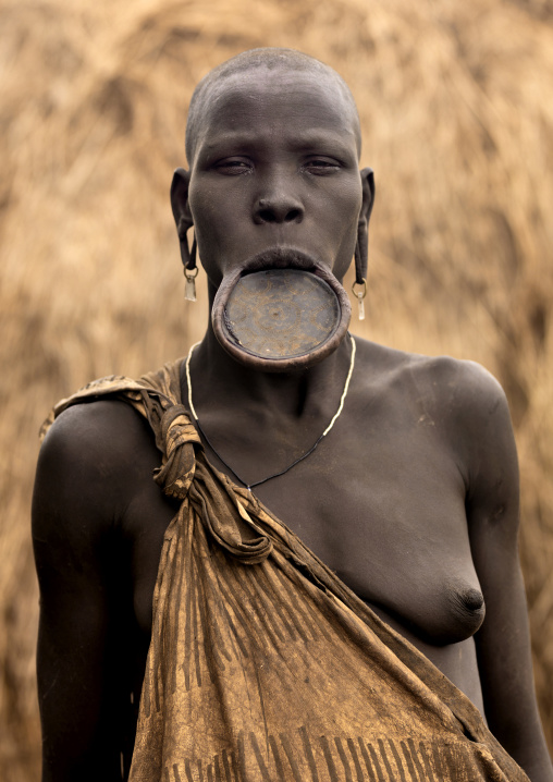 Portrait Of A Mursi Tribe Woman With Lip Plate And Enlarged Ears In Mago National Park, Omo Valley, Ethiopia