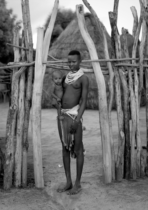 Black And White Portrait Of A Karo Tribe Mother And Kid At The Entrance Of Their Hut, Korcho Village, Omo Valley, Ethiopia