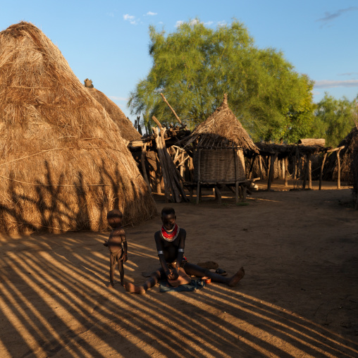 Karo Woman And Baby Sitting In The Middle Of Karo Huts Omo Valley Ethiopia