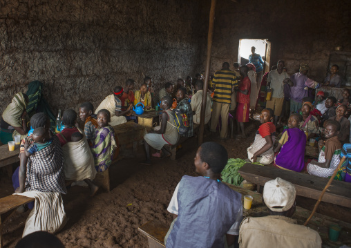 People from menit tribe drinking honey wine, Jemu, Omo valley, Ethiopia