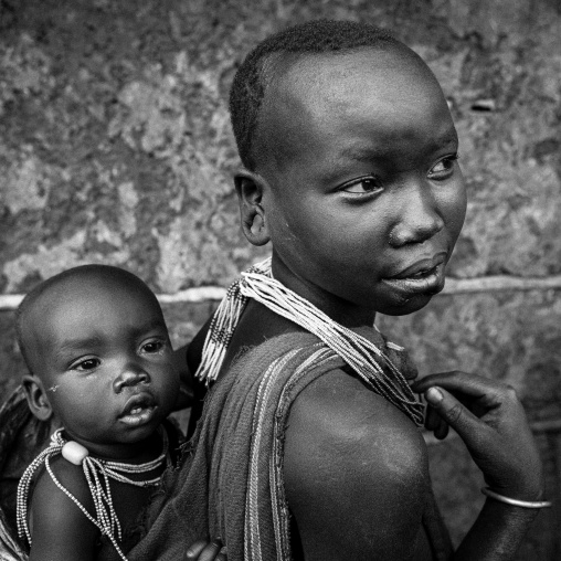 Suri tribe woman holding her baby, Kibish, Omo valley, Ethiopia