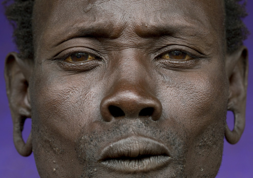 Suri tribe man with enlarged earlobes, Kibish, Omo valley, Ethiopia