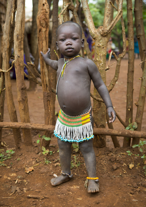 Suri tribe girl with a beaded skirt, Kibish, Omo valley, Ethiopia