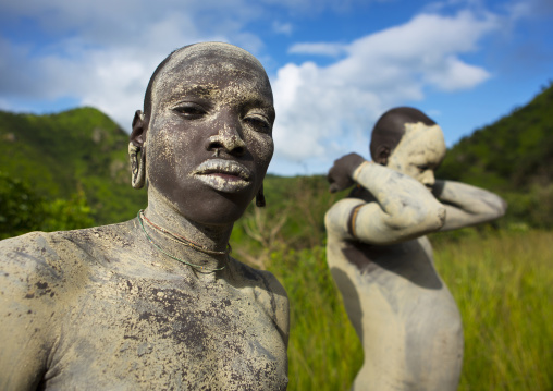 Suri tribe shephers with body paintings as camouflage, Tulgit, Omo valley, Ethiopia