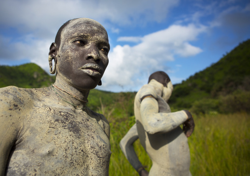 Suri tribe shephers with body paintings as camouflage, Tulgit, Omo valley, Ethiopia