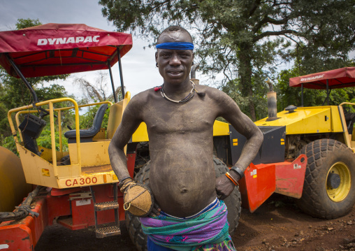 Bodi Tribe Warrior Posing Proudly Near A Bulldozer Near Hana Mursi, Omo Valley, Ethiopia