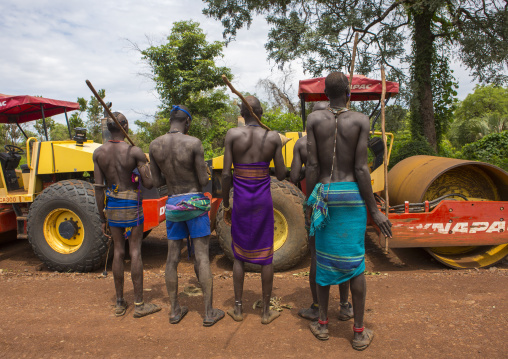 Bodi Tribe Warriors Looking At A Bulldozer Near Hana Mursi, Omo Valley, Ethiopia