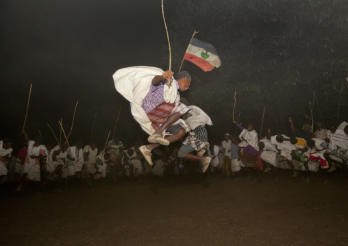 Night Shot Of Two Karrayyu Tribe Men Jumping High During A Choreographed Stick Fighting Dance At Gadaaa Ceremony, Metahara, Ethiopia