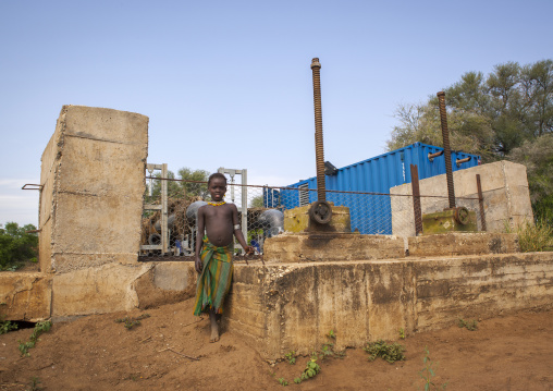 Dassanech Girl In Front Of A Water Pump On Omo River, Omorate, Omo Valley, Ethiopia