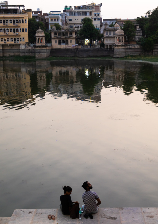 Couple sit on Gangaur ghat, Rajasthan, Udaipur, India