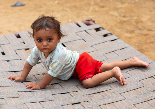 Portrait of a rajasthani toddler on a bed, Rajasthan, Jaisalmer, India